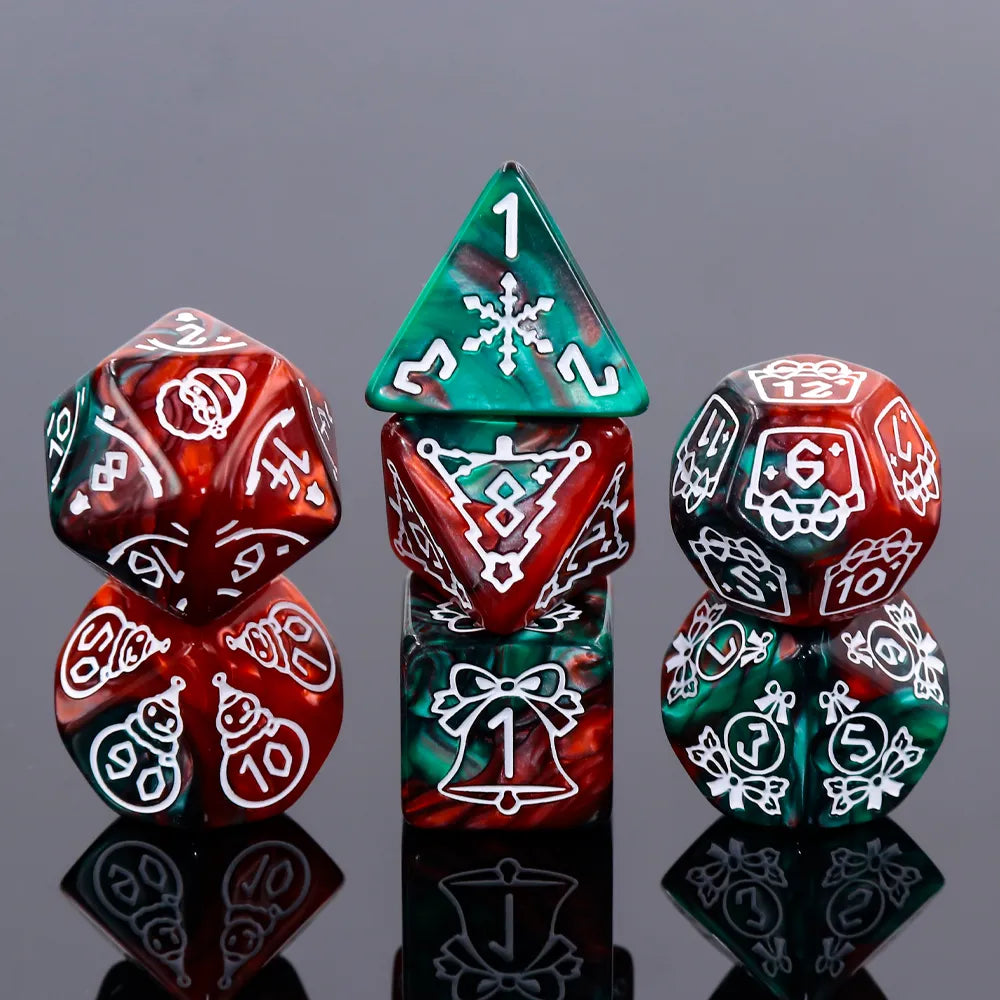 A set of seven multicolored dice with Christmas-themed decorations, including designs such as snowflakes and bells, displayed on a reflective surface.